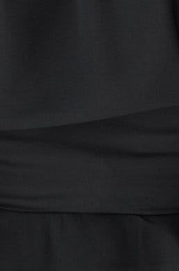 Close-up of smooth black chiffon fabric, showcasing elegant draping and texture of the Fleur Top.