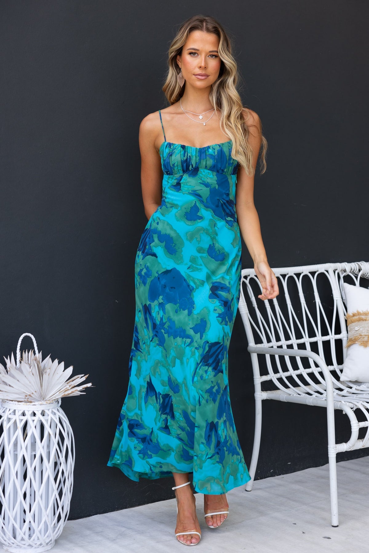 Freyda Maxi Dress featuring floral print, adjustable straps, and cut-out back in vibrant blue tones.