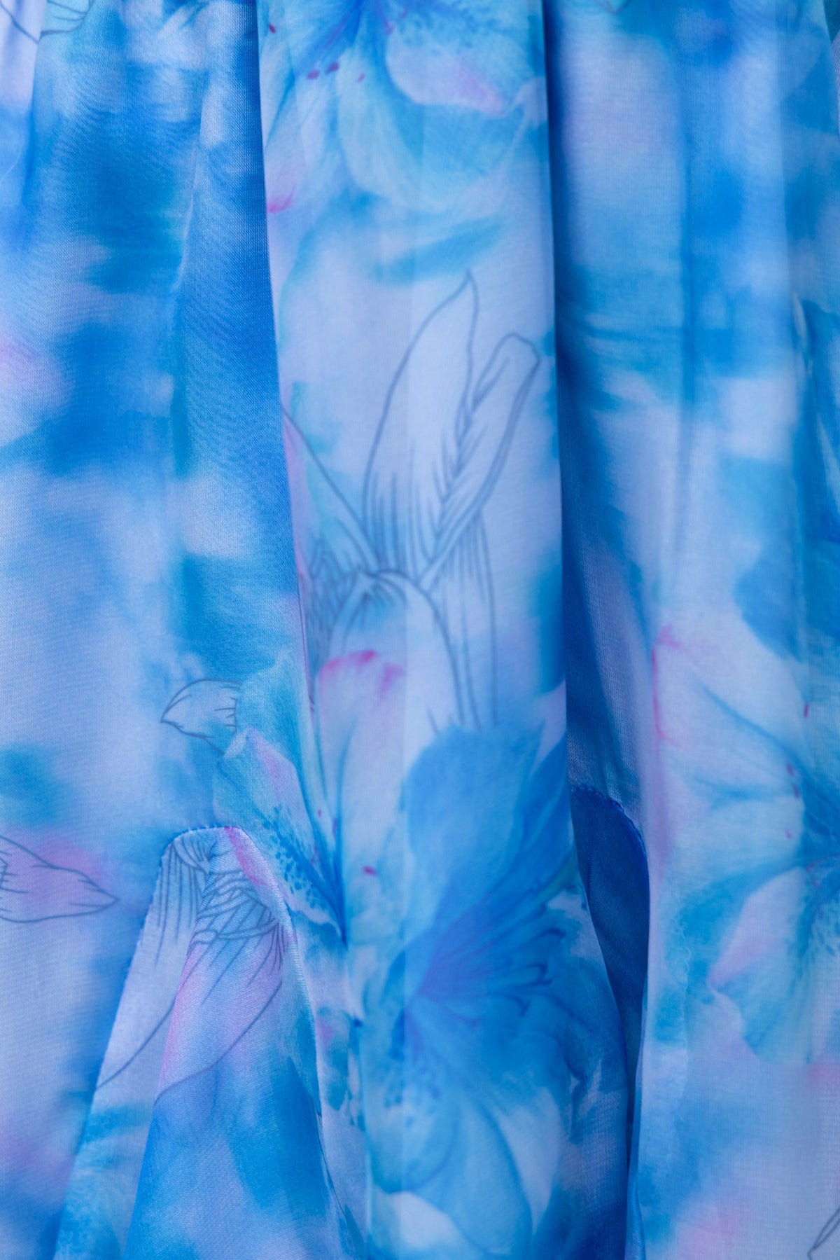Close-up of the Azul Dress featuring a vibrant blue floral pattern on light chiffon fabric.
