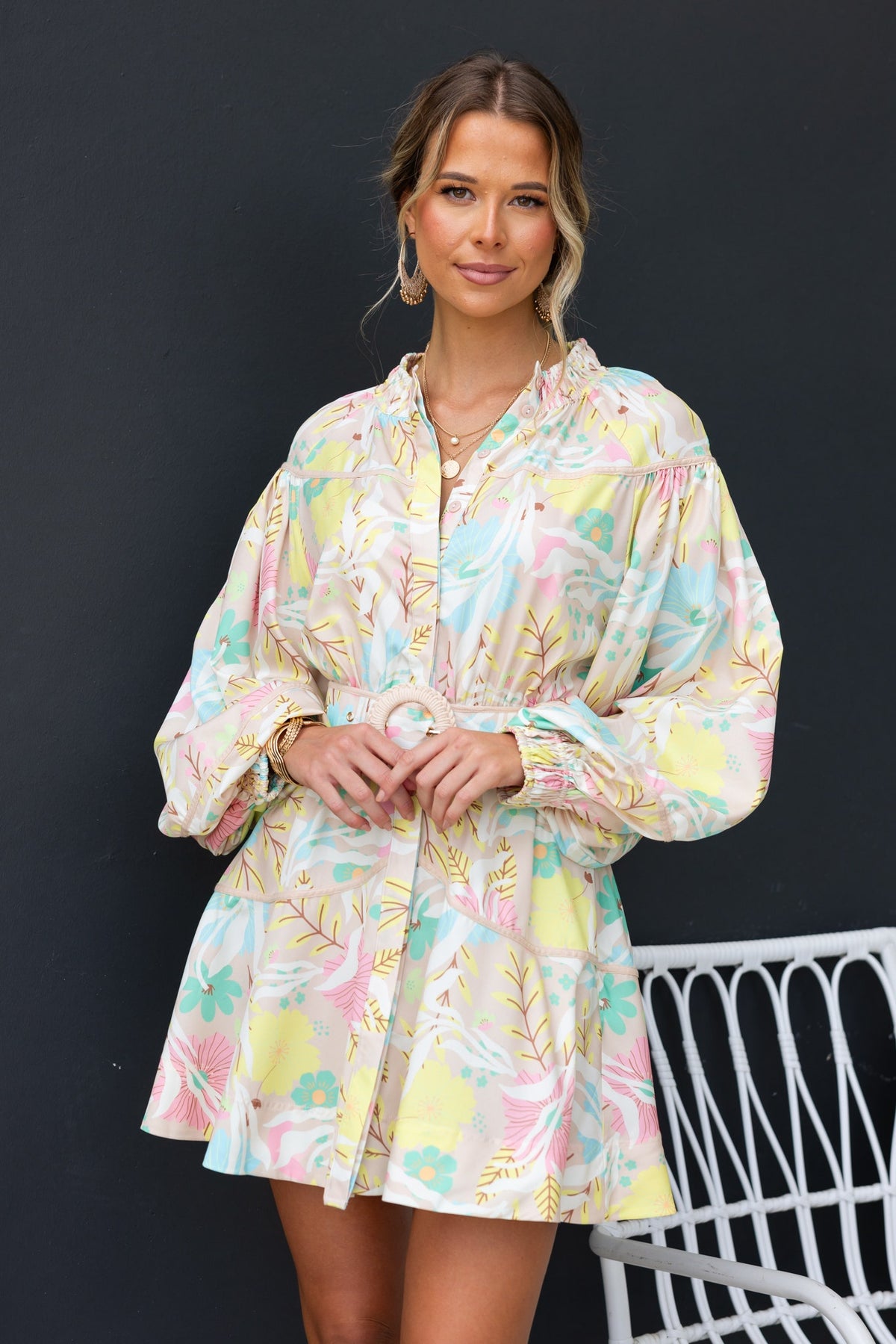 Antonia Dress featuring elastic neckline, button-up front, removable belt, and vibrant floral print, perfect for summer outings.