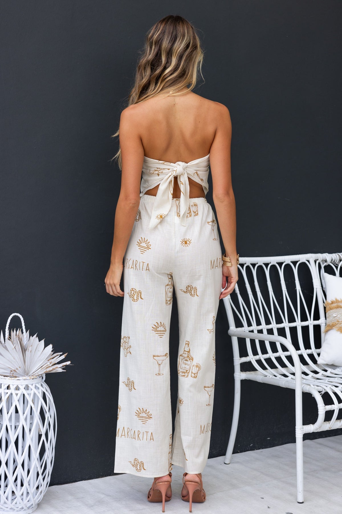 Back view of Tijuana Set, featuring a tied strapless top and mid-high waist pants with a cotton feel.