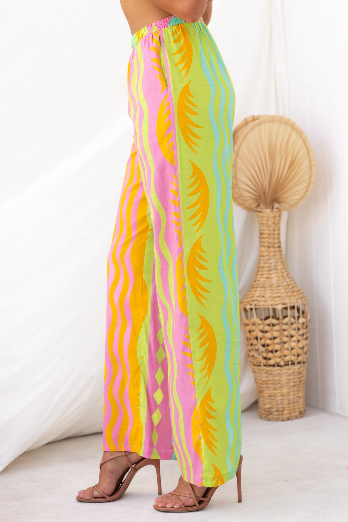 Verney Pants in vibrant colors with wave patterns, featuring an elastic waistband and a relaxed, stylish fit.