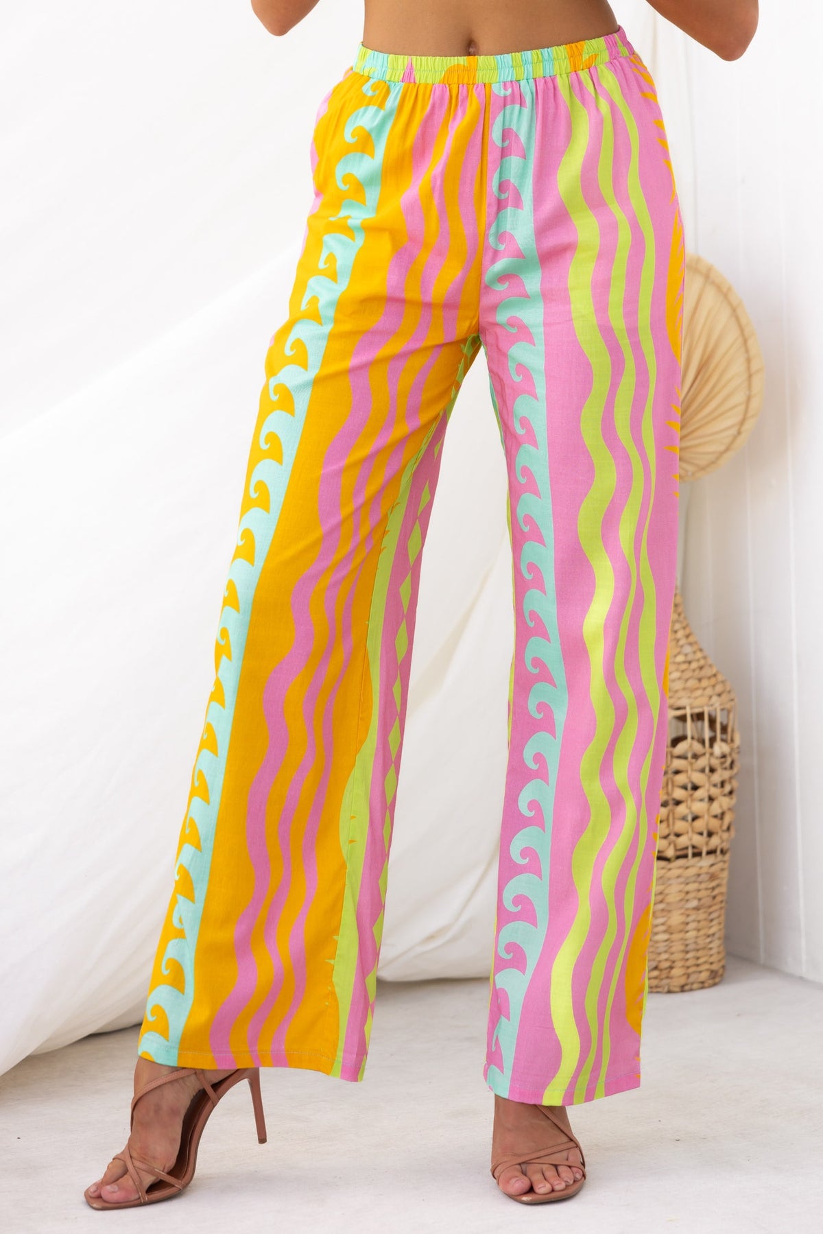 Colorful Verney Pants with mid-high waist, elastic waistband, and wave pattern in pink, yellow, and green.