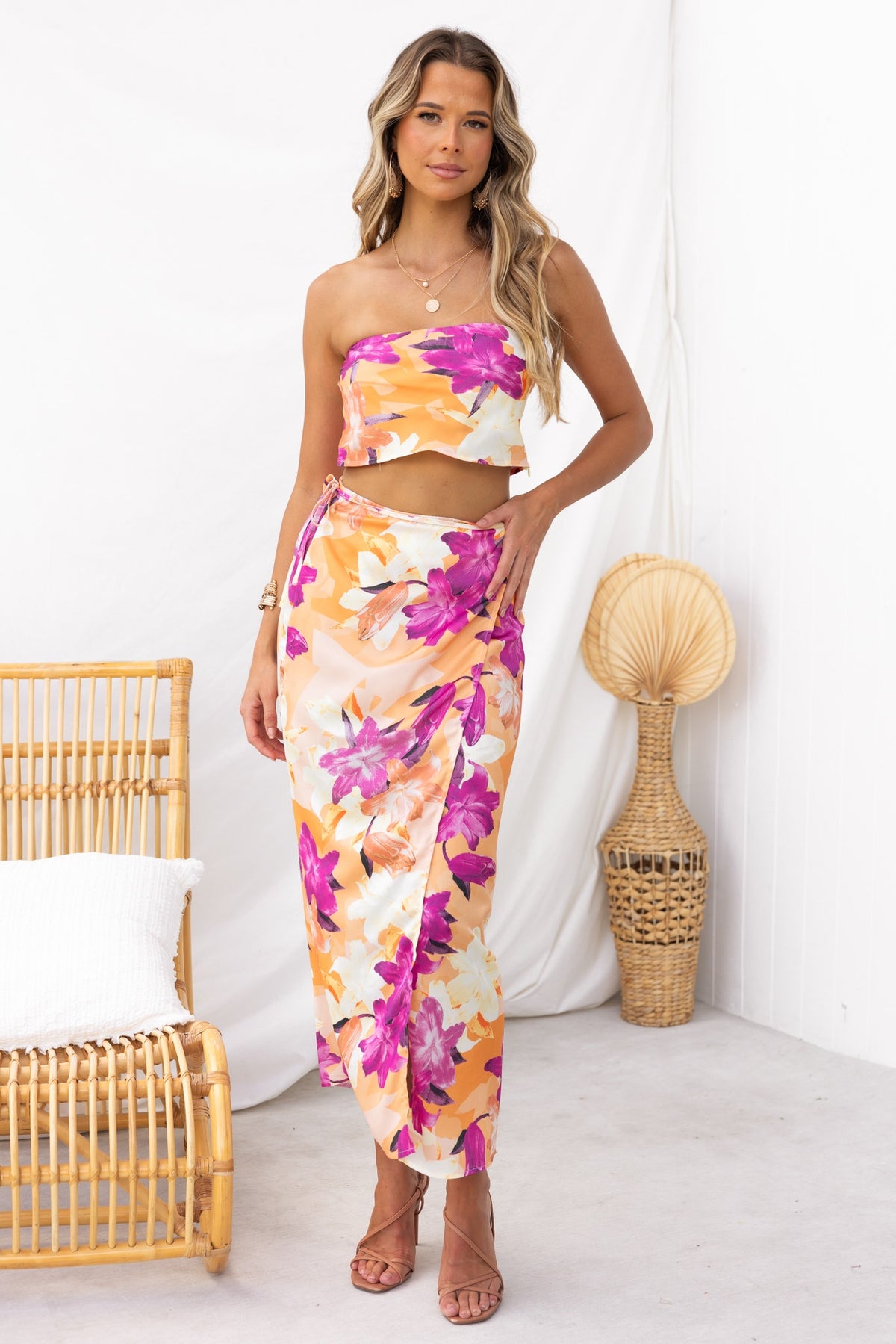 Model wearing Nerida Wrap Midi Skirt with floral print, showcasing asymmetric hem and satin finish.