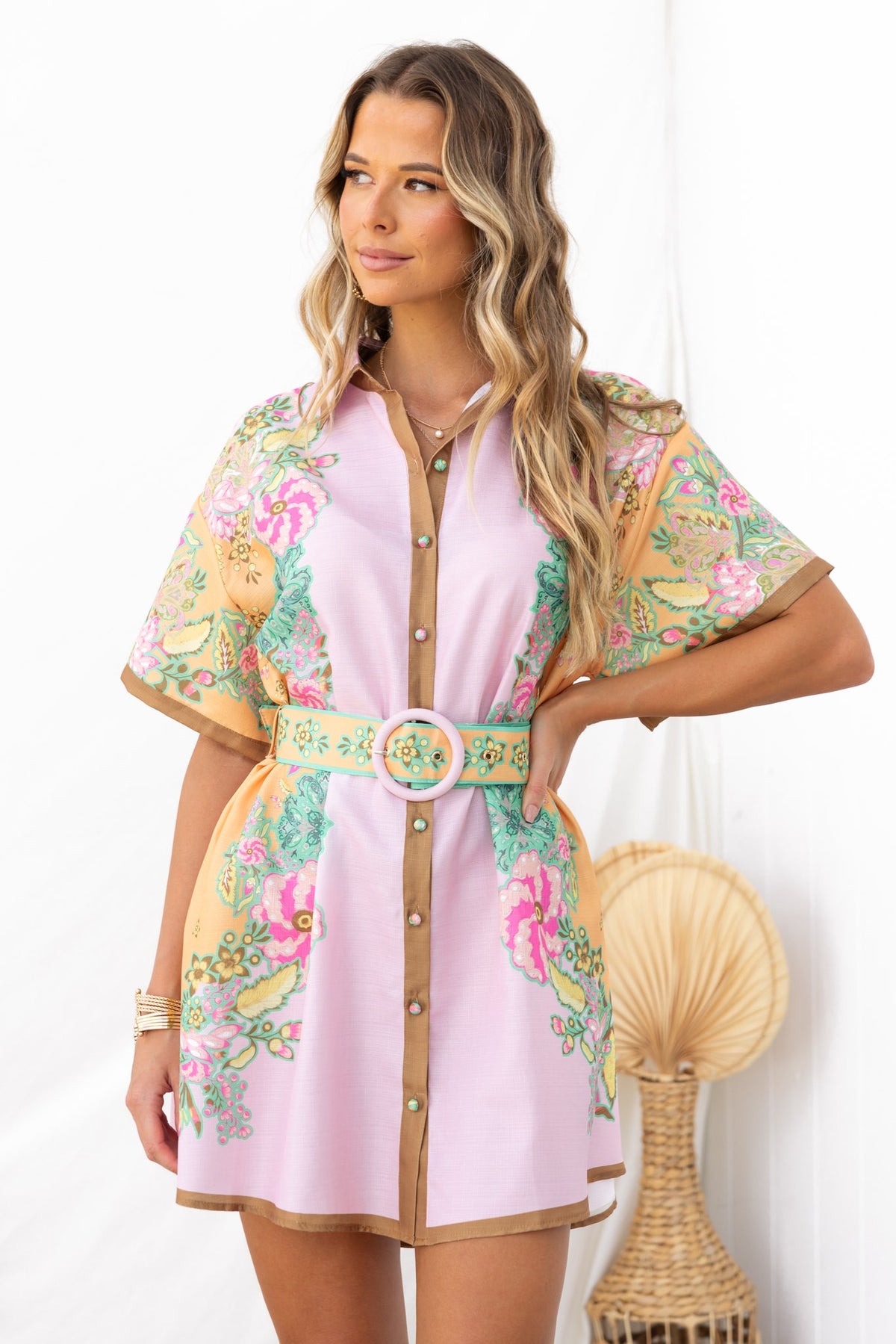 Stylish Jaziel Dress in pink with floral design, button-up front, and removable belt, perfect for a relaxed fit.