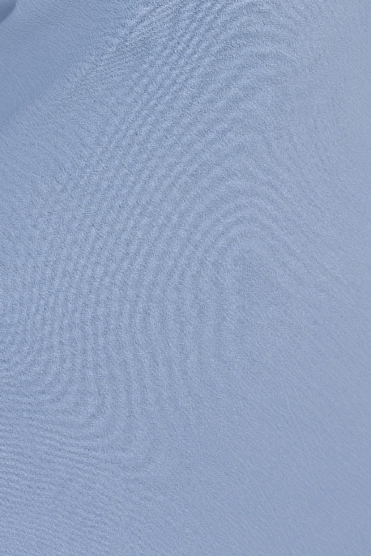 Textured light blue fabric for Zhuri Dress, showcasing the material details and color.