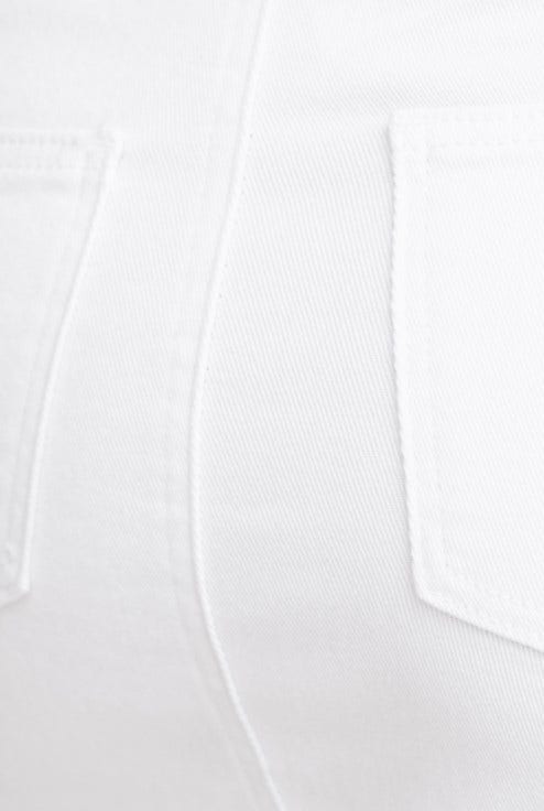 Close-up of white denim fabric showcasing back pockets and texture details.