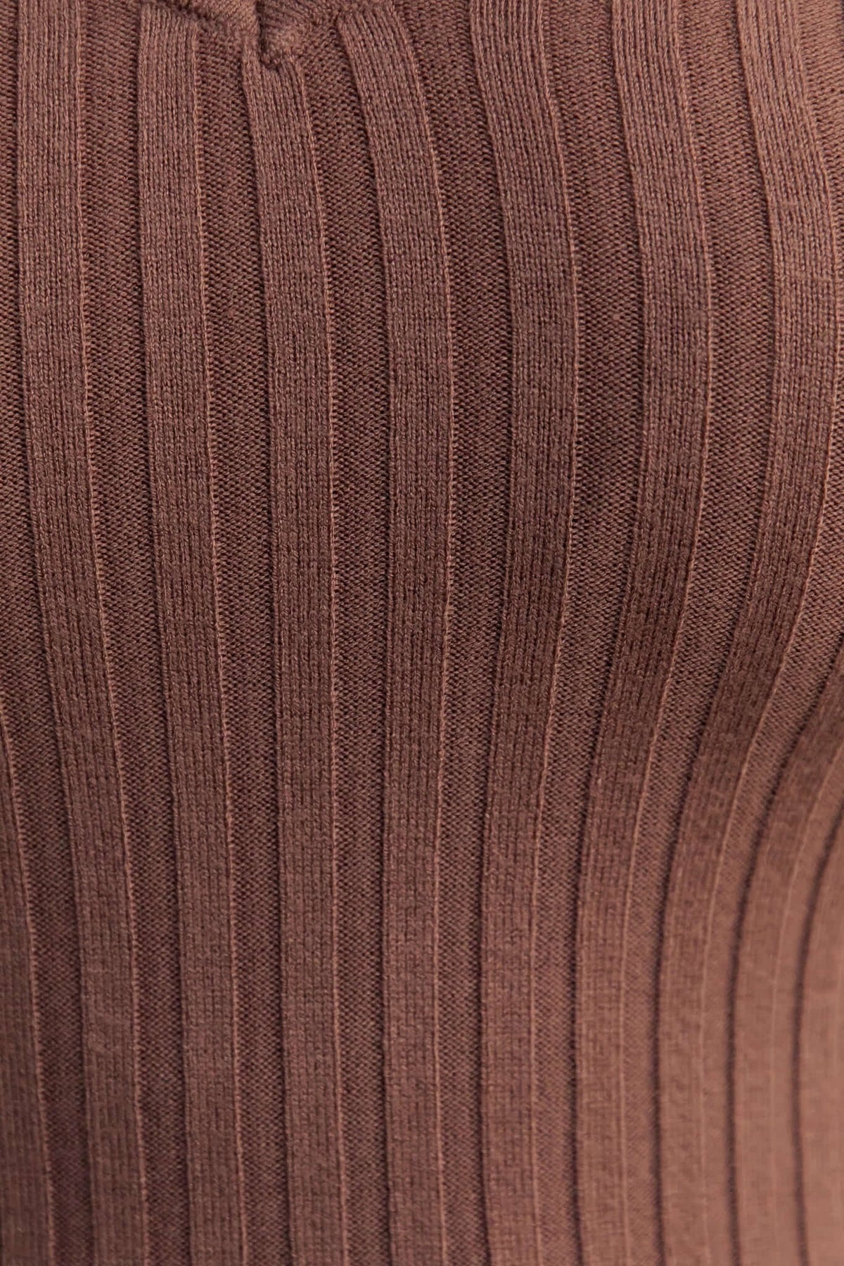 Close-up of ribbed knit material of the Aquino Midi Dress in rich brown, showcasing its stretchy and textured fabric.