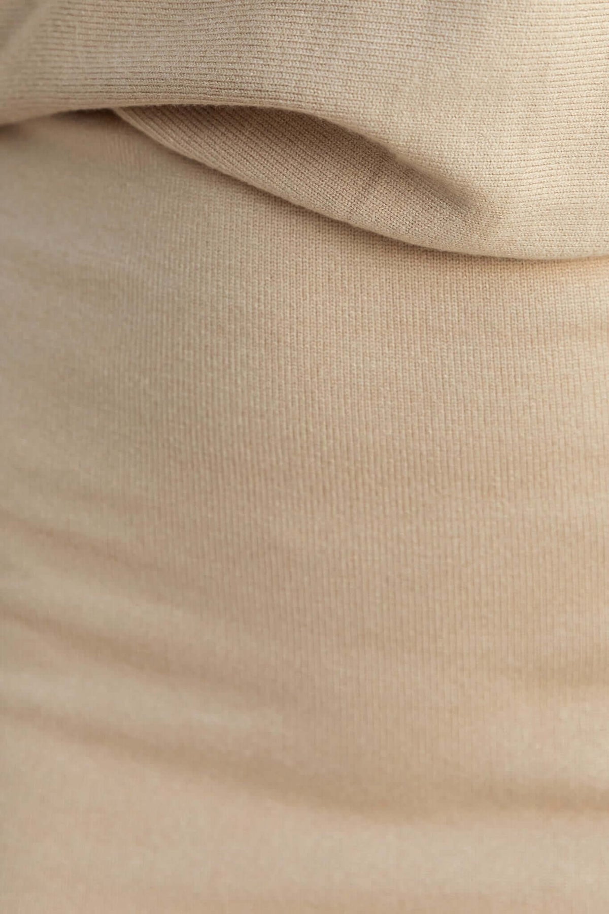 Close-up of soft beige knit fabric showcasing stretch and texture for Gaskin Midi Dress.