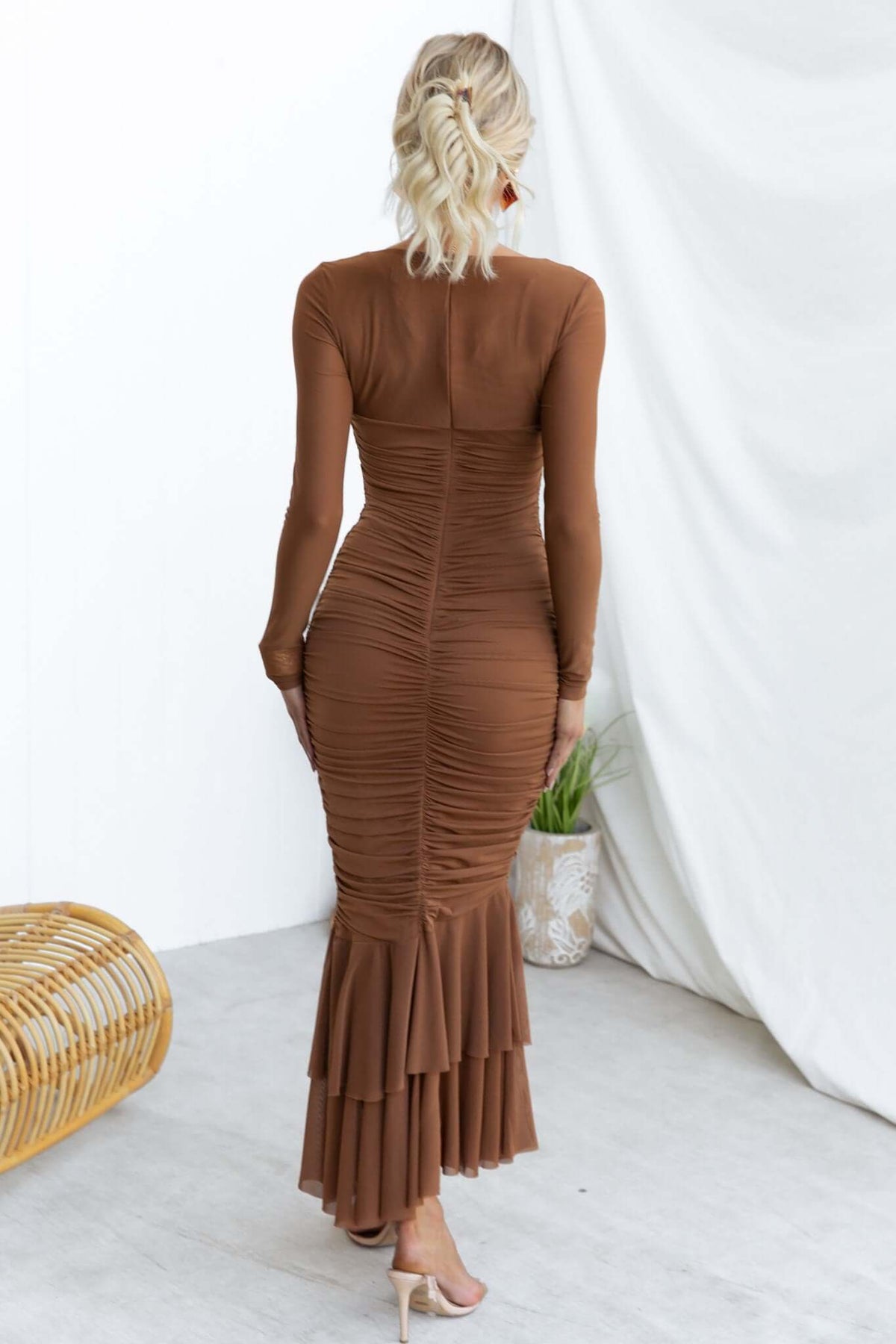 Back view of Zhari Maxi Dress featuring cut-out, twist detail, and ruched design in a rich brown color.