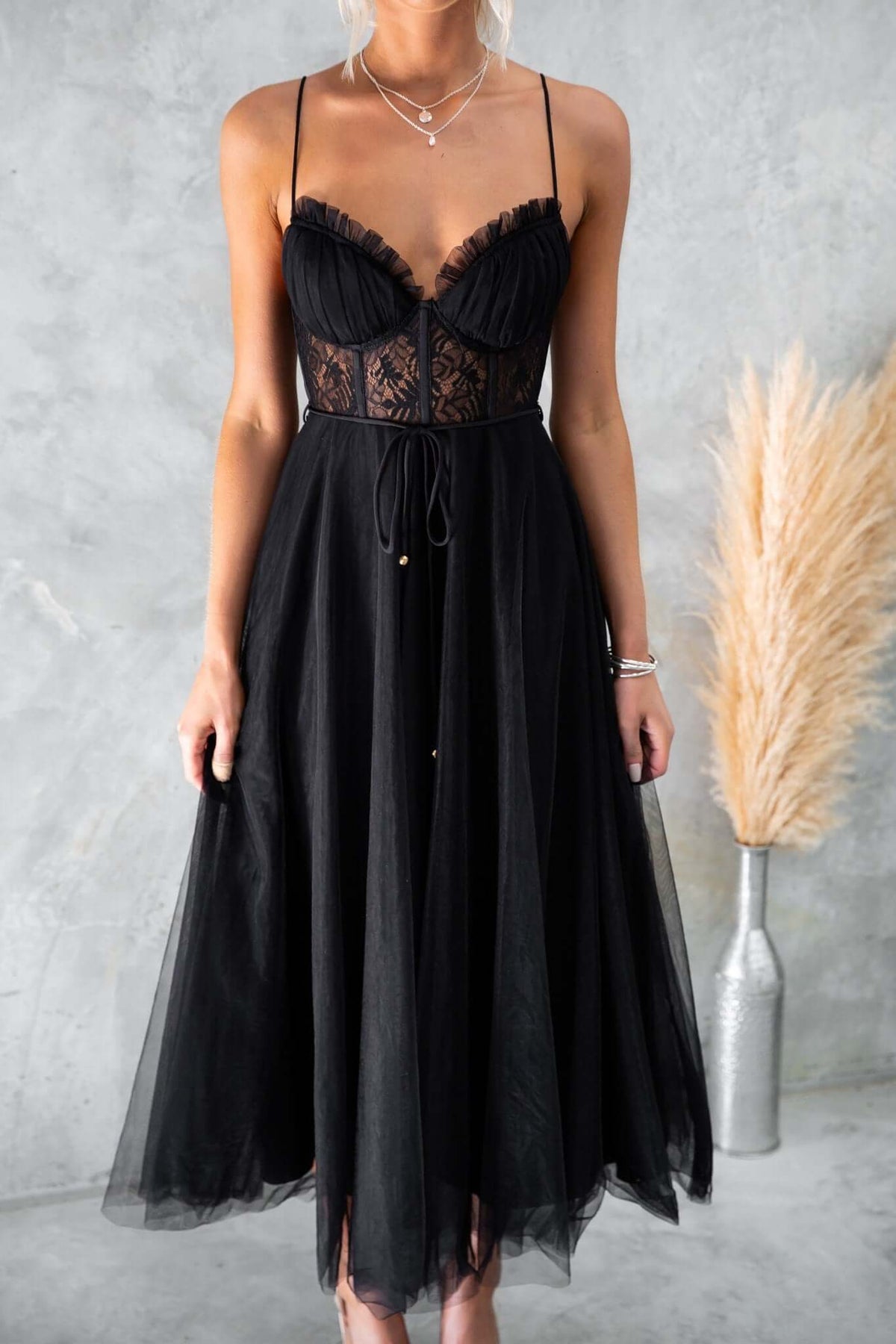 Black tulle maxi dress with adjustable straps, padded bust, lace detail, and removable fabric tie.