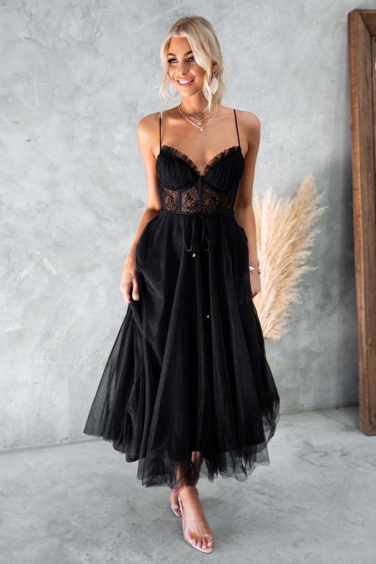 Black tulle maxi dress with adjustable straps, padded bust, lace detail, and removable tie.