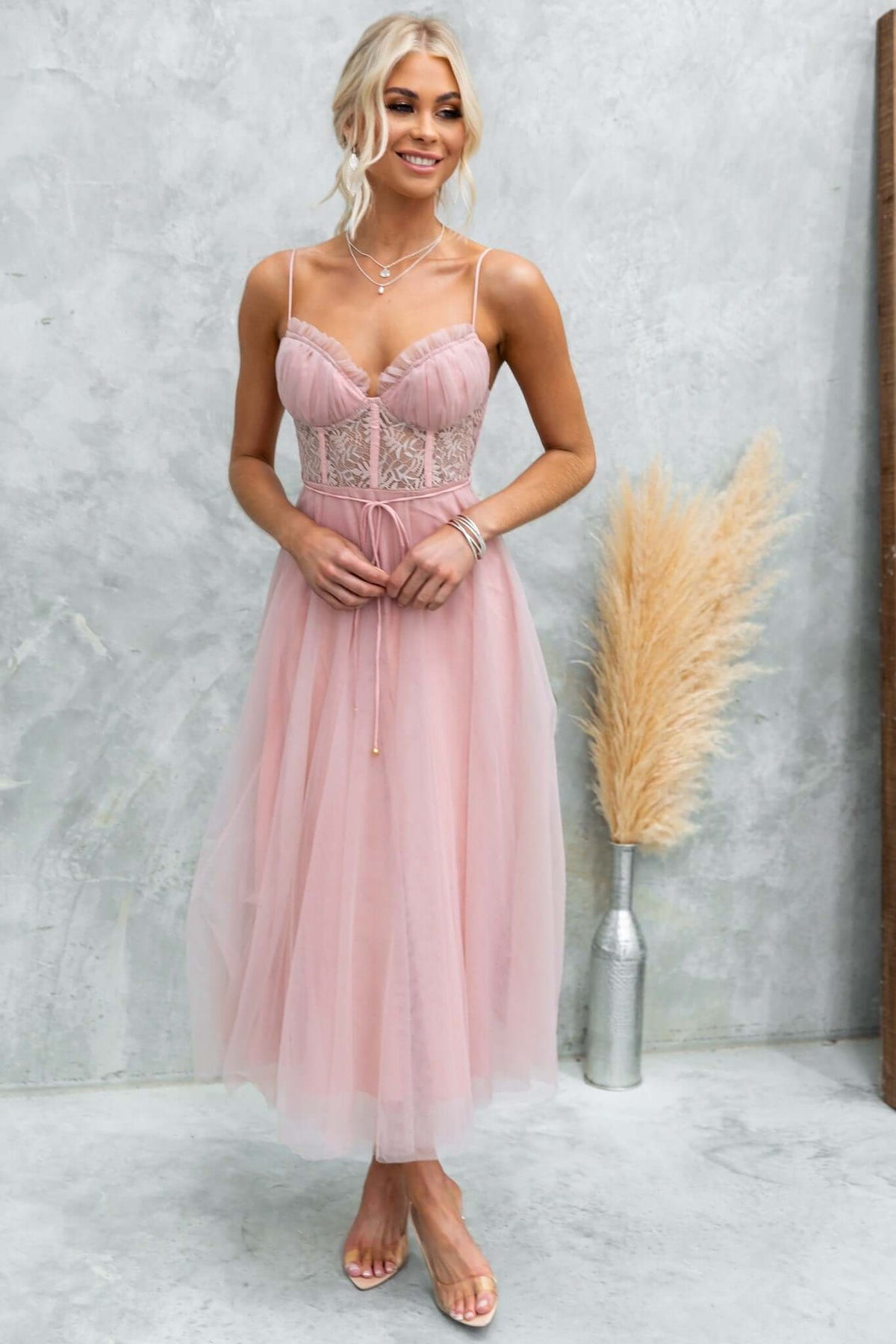 Model wearing a Wash Away Maxi Dress, featuring tulle, lace detail, and adjustable straps in soft pink.