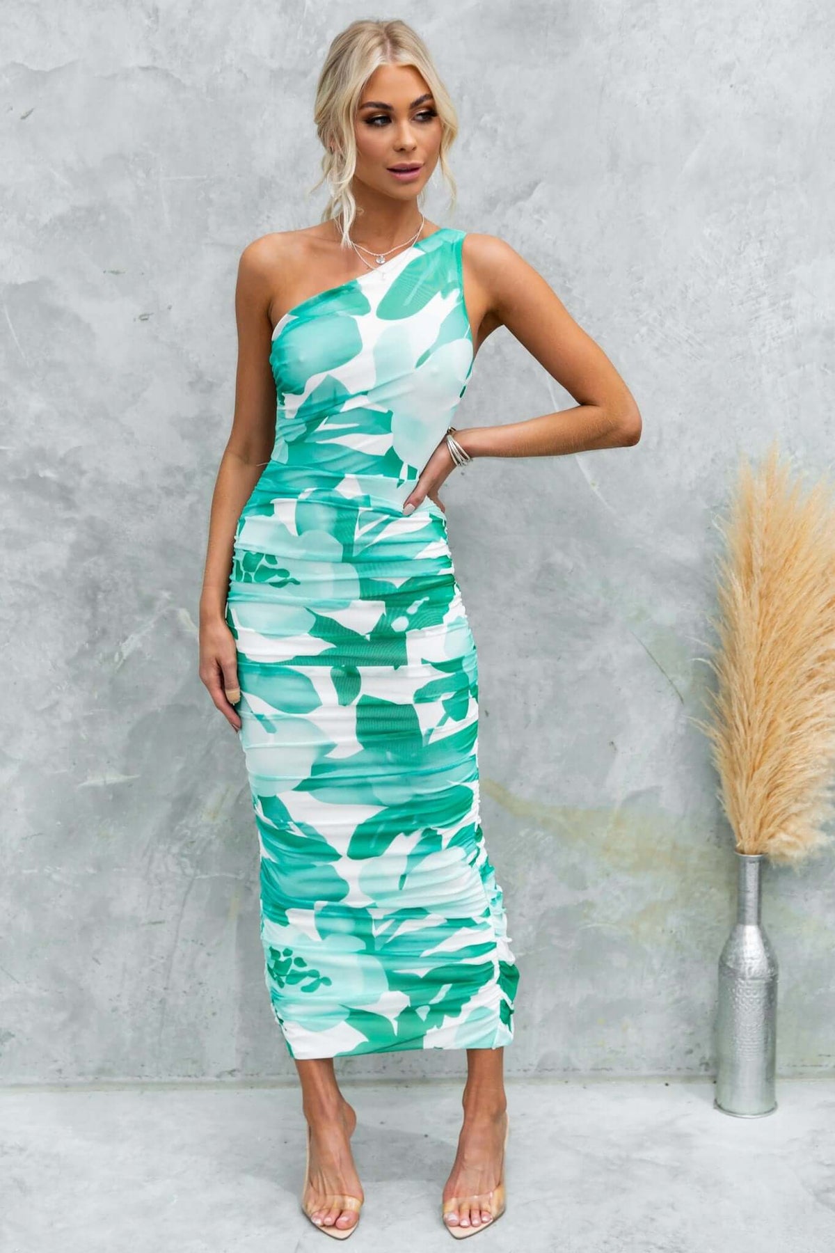 Model wearing Stolen Kiss Maxi Dress featuring a one-shoulder neckline and green floral design, perfect for evening wear.