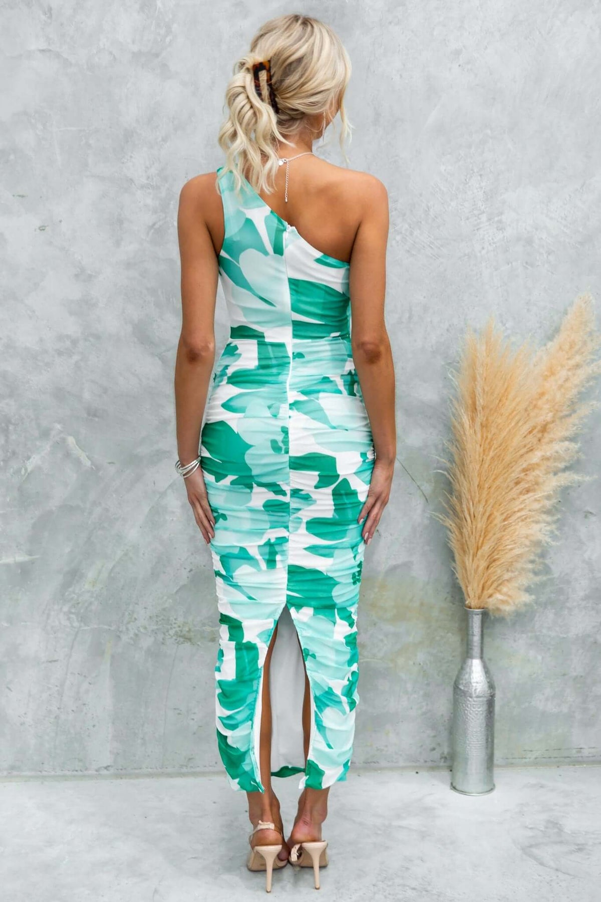 Back view of Stolen Kiss maxi dress featuring one-shoulder design, ruched details, and split at the back.