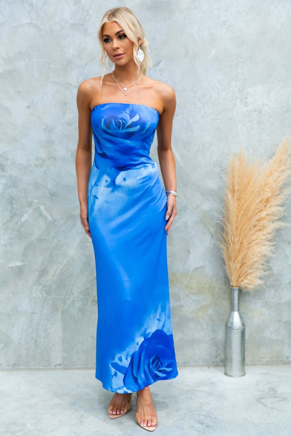 Model wearing the Dyxon Maxi Dress, a strapless blue dress with floral design, perfect for summer events.