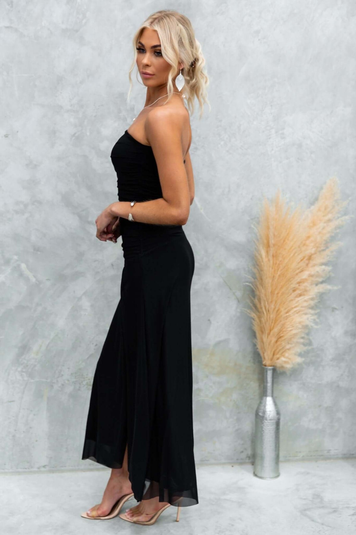 Model in a black strapless Legrand Maxi Dress with split, showcasing stylish and comfortable fit.