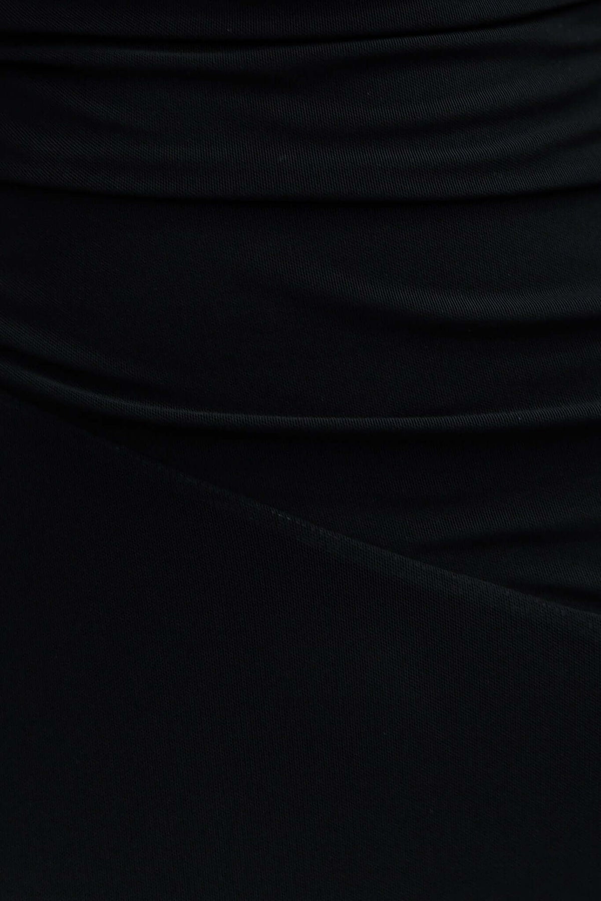 Close-up of Zhari Black Maxi Dress fabric, showcasing ruching detail and smooth mesh overlay material.