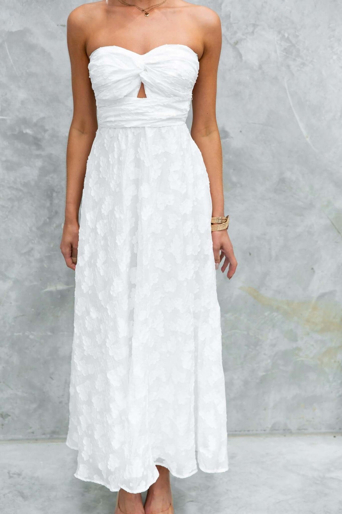 Ivrea Maxi Dress in white, strapless design with a keyhole detail and textured fabric, perfect for elegant occasions.