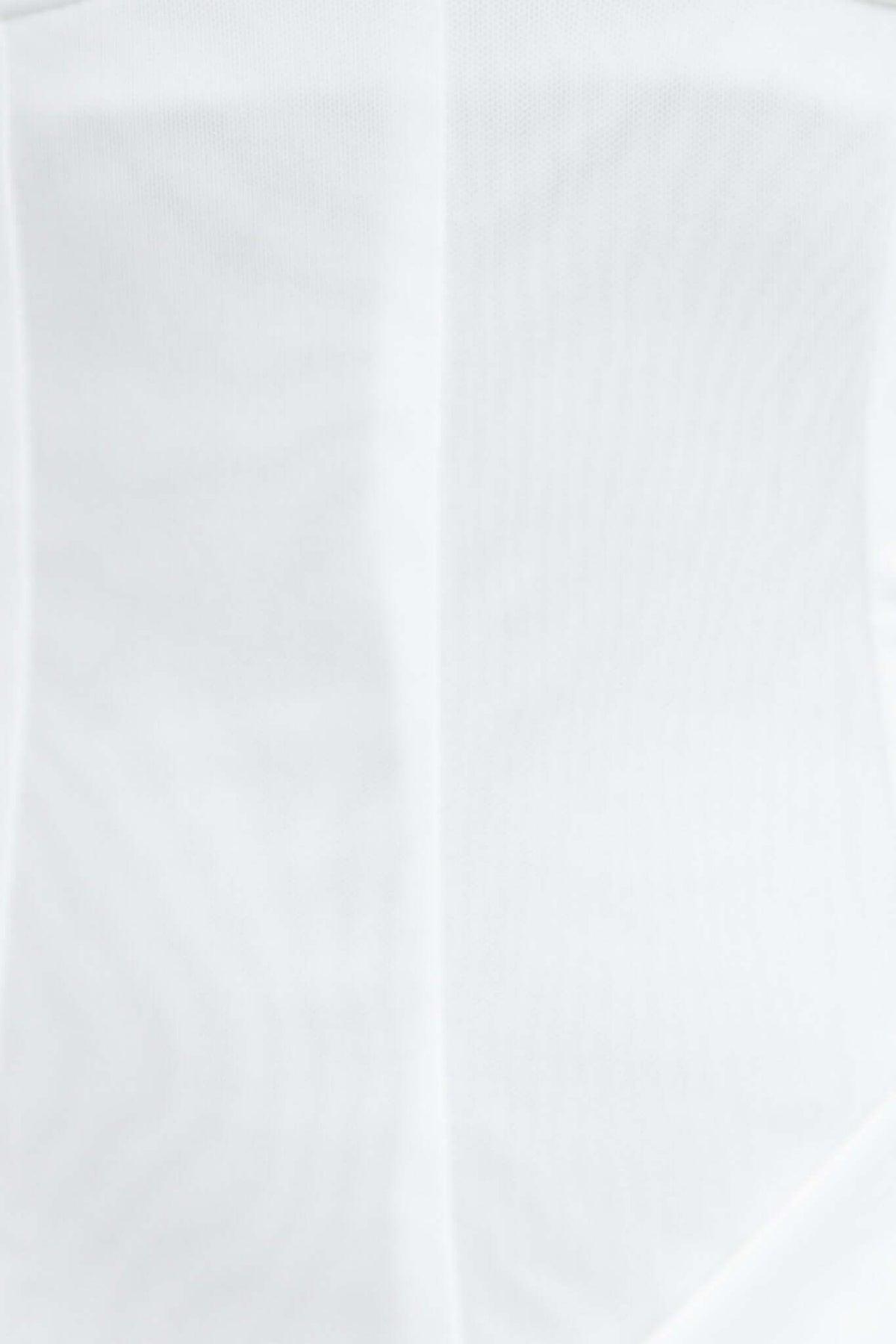 Close-up of the textured white mesh material of the Bobbio Dress, showcasing its elegant design and light, draping qualities.