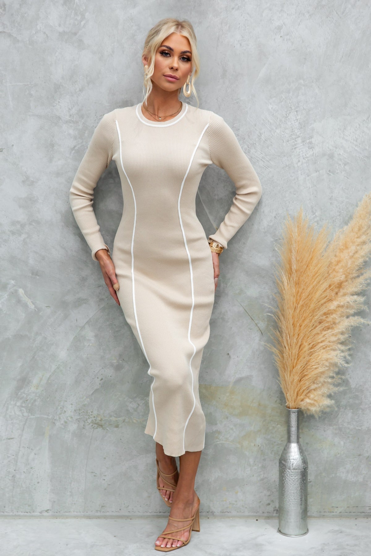 Model wearing Saculla Midi Dress in cream ribbed knit with white accents, styled with minimalist accessories.