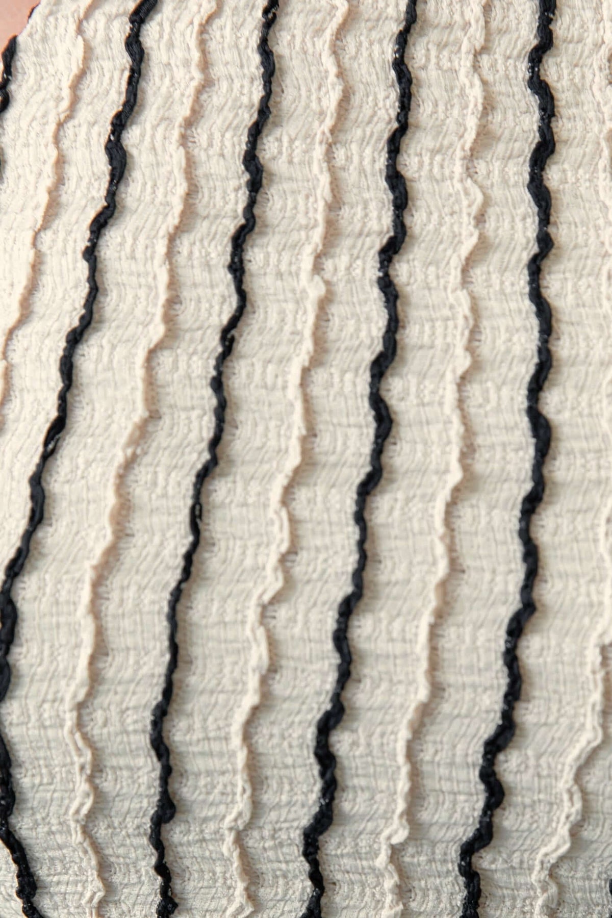 Close-up of textured fabric with black wavy stripes on a light background, ideal for Moreno Maxi Dress.
