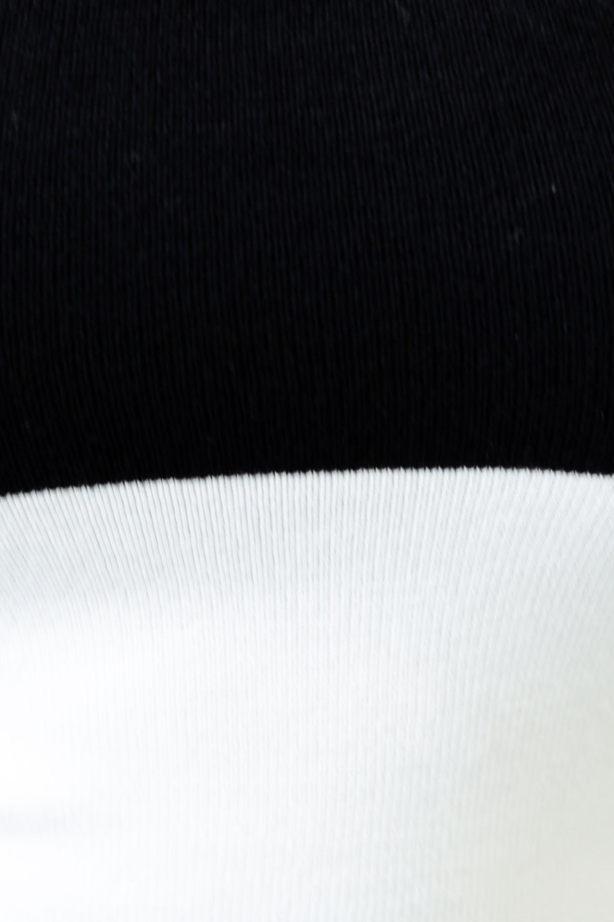 Close-up detail of the Alonza Midi Dress showcasing the black and white knit fabric texture.