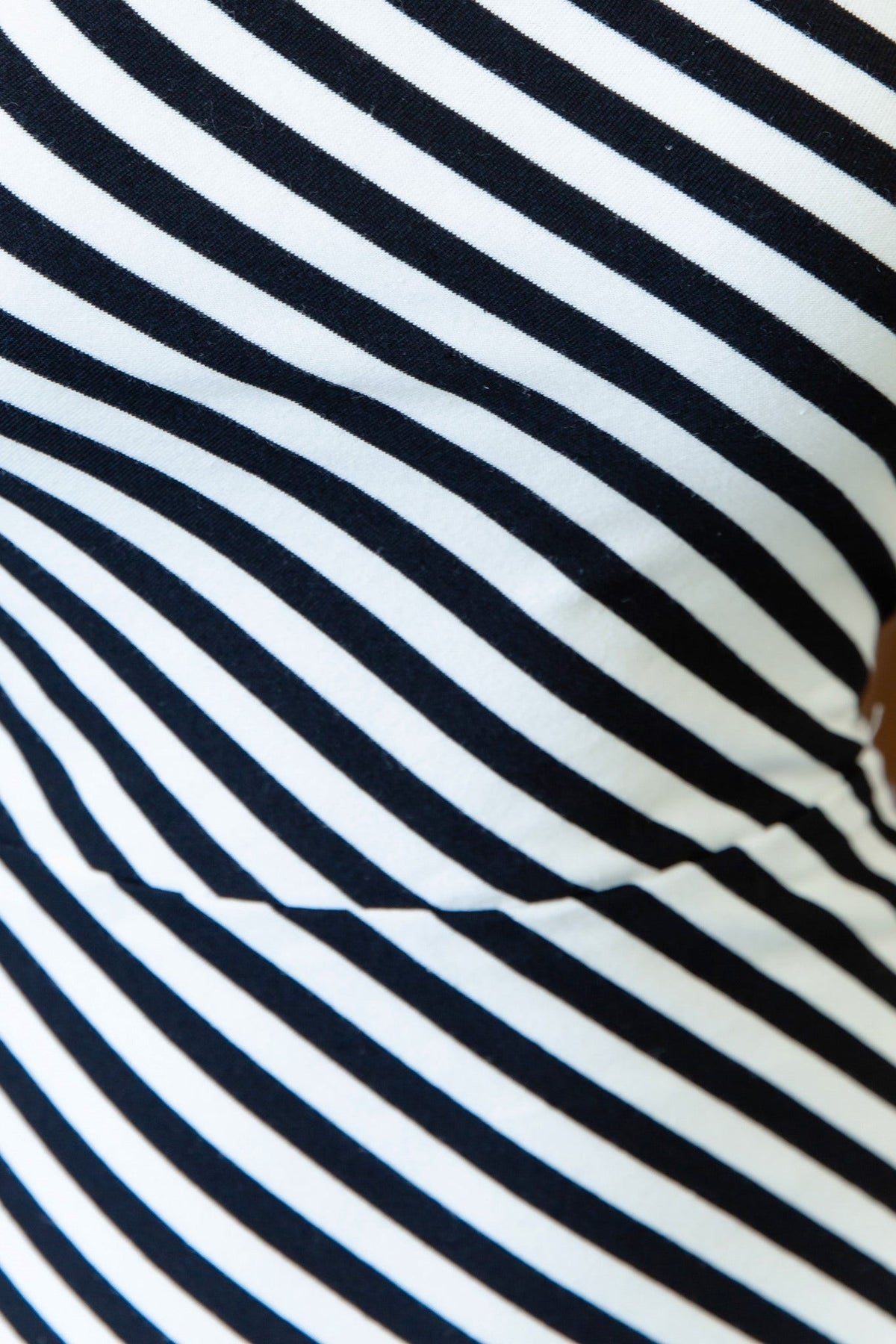 Close-up of black and white striped fabric showcasing the texture and design of a dress.
