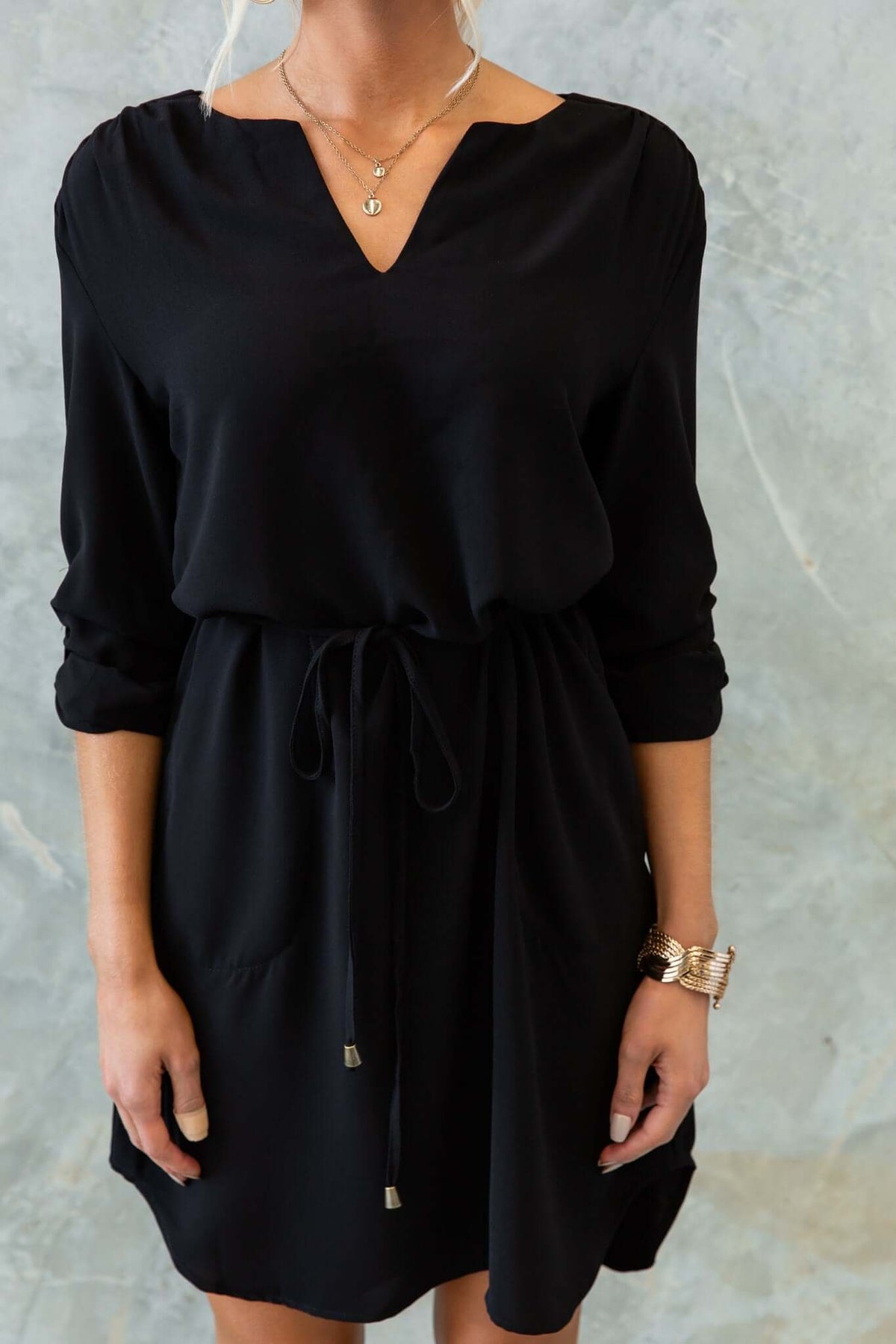 Black Deklyn Dress with V-neckline and removable tie, featuring pockets and a standard fit.