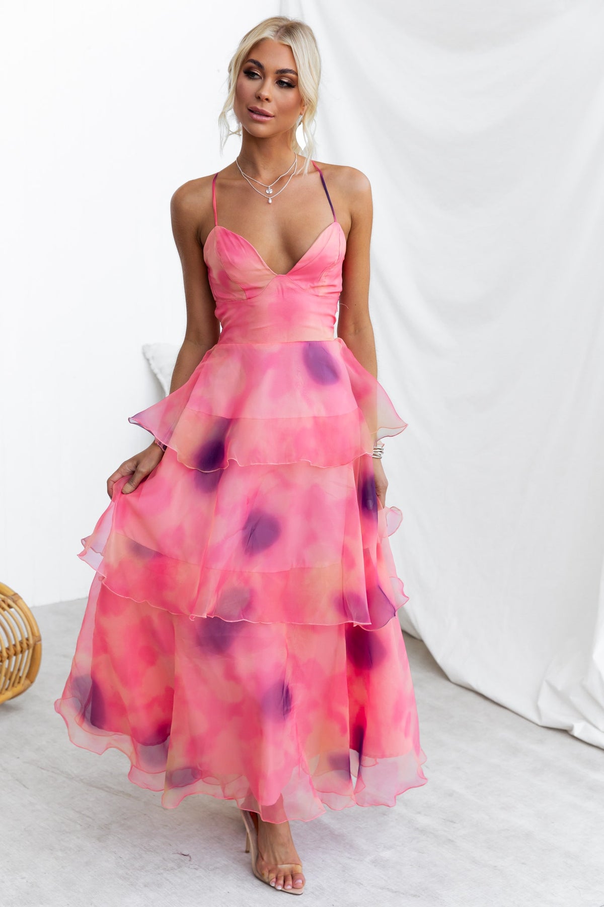 Elinor Maxi Dress in pink chiffon with adjustable straps and ruffle skirt, perfect for summer occasions.