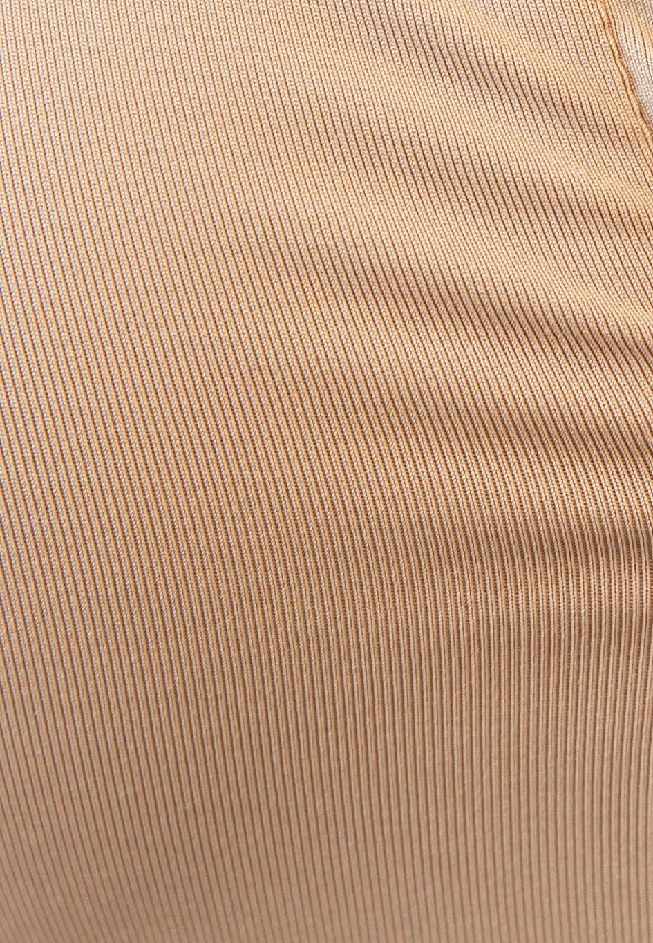 Close-up of a beige ribbed fabric, showcasing texture and stretch of the Unfair Bodysuit.