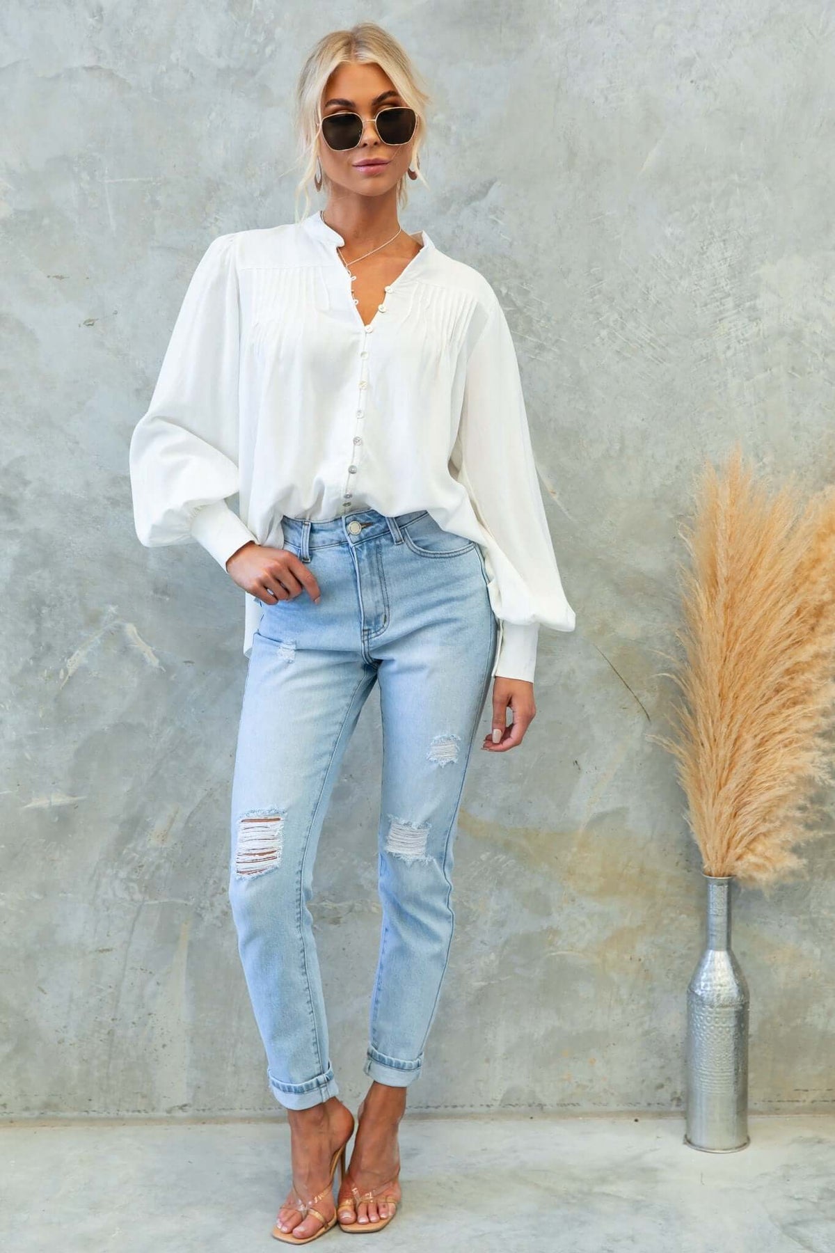 Model wearing a Brunie shirt with button-up front, relaxed fit, paired with light blue distressed jeans.
