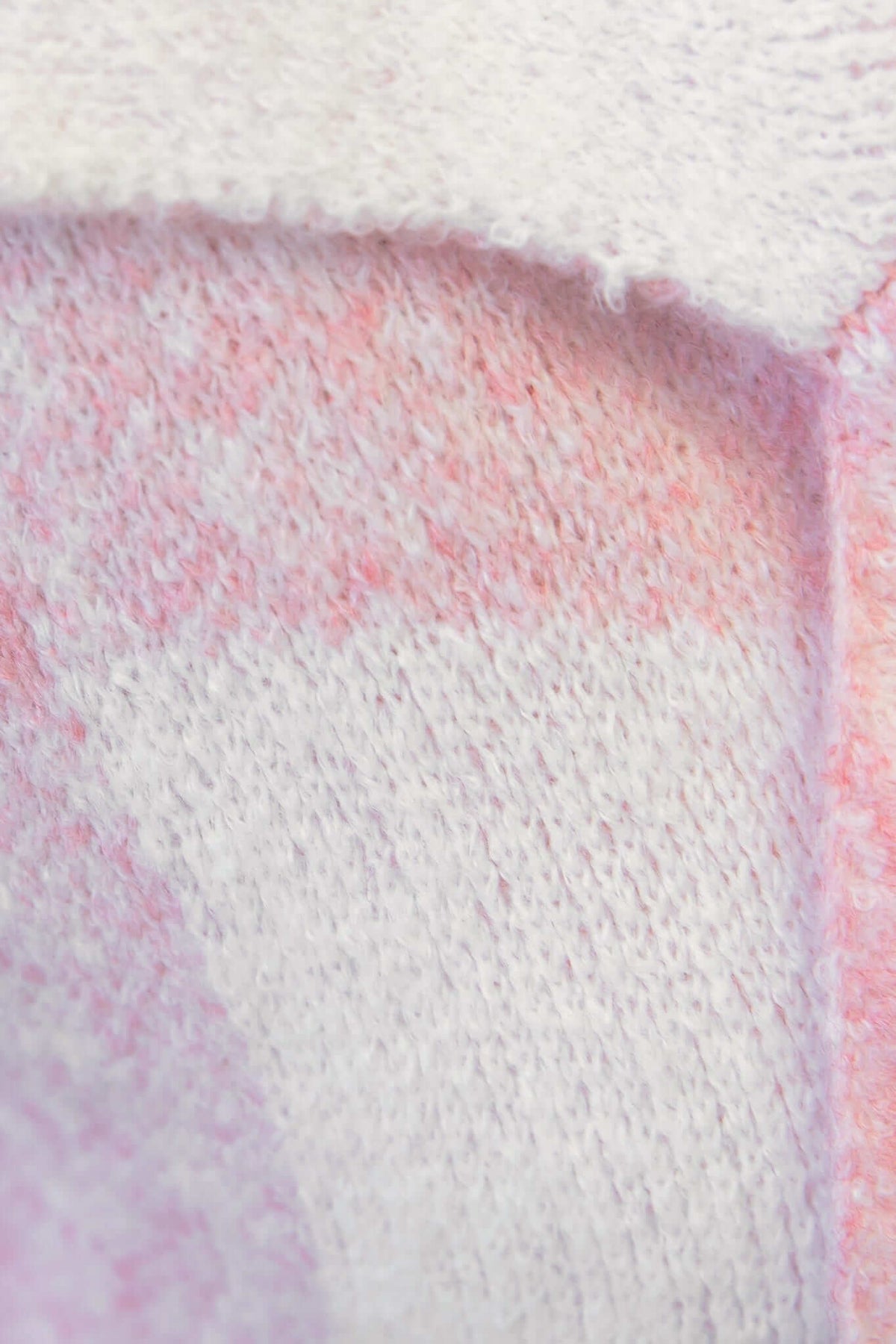 Close-up of soft knitted fabric featuring a pink and white ombre pattern, ideal for the Fatale Cardigan.