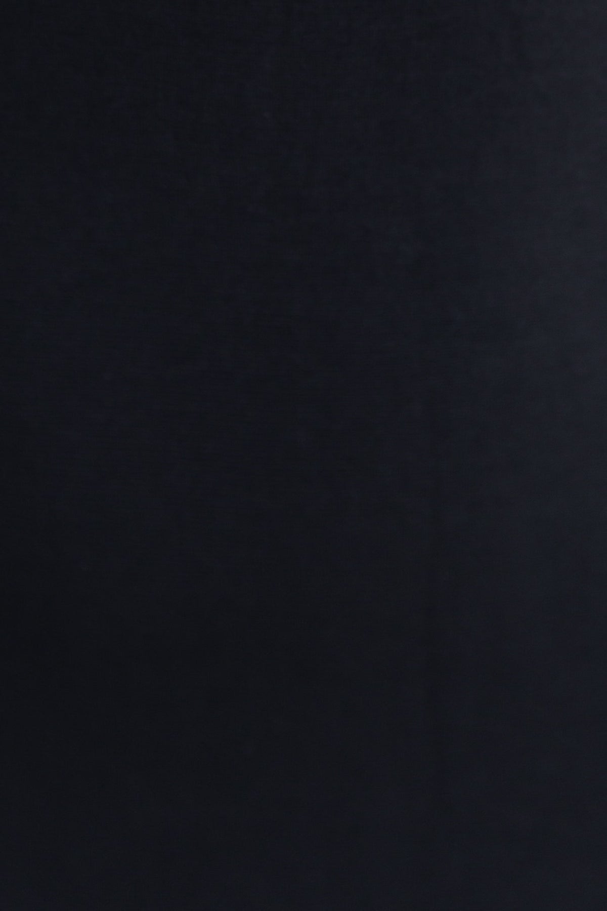 Close-up of textured black fabric for the Forli Maxi Dress, showcasing its rich color and quality material.