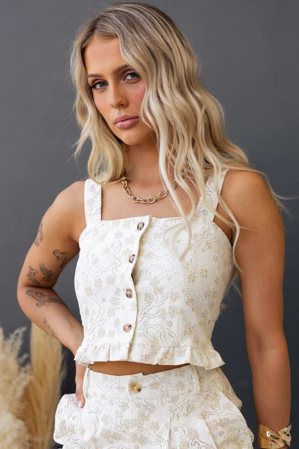 Ella Top with adjustable straps and button-up front in a floral design, styled with a matching skirt.