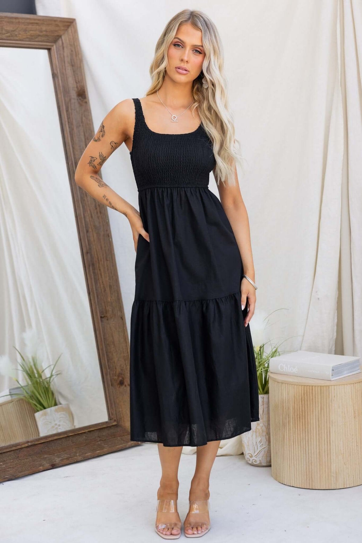 Haidy Midi Dress in black featuring elastic bodice, pockets, and a tiered design.