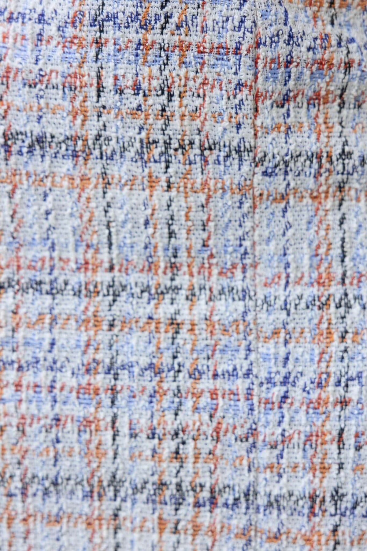 Close-up of textured fabric in blue, orange, and black plaid pattern for a Tahina Skirt.