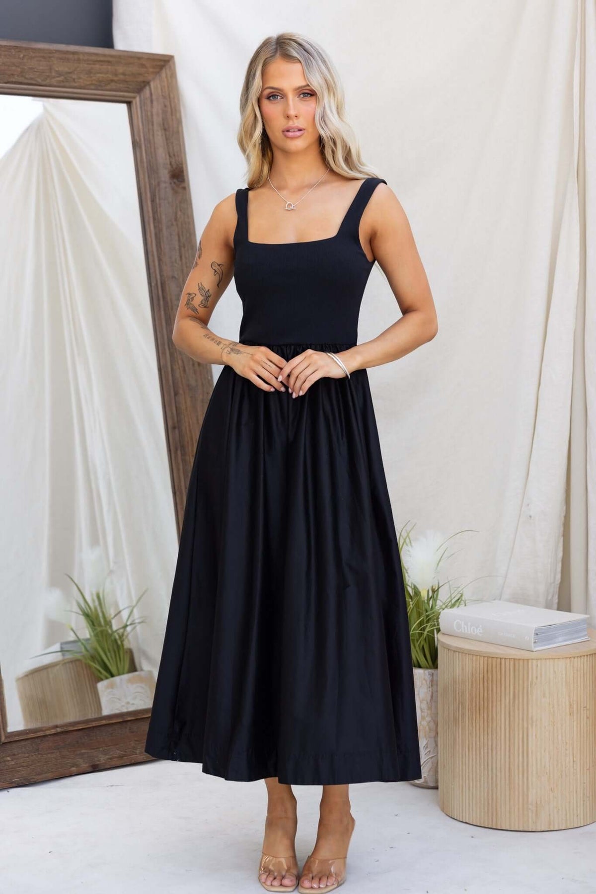 Flint Maxi Dress featuring a fitted jersey bodice, flowy skirt, and pockets, styled elegantly for a casual look.
