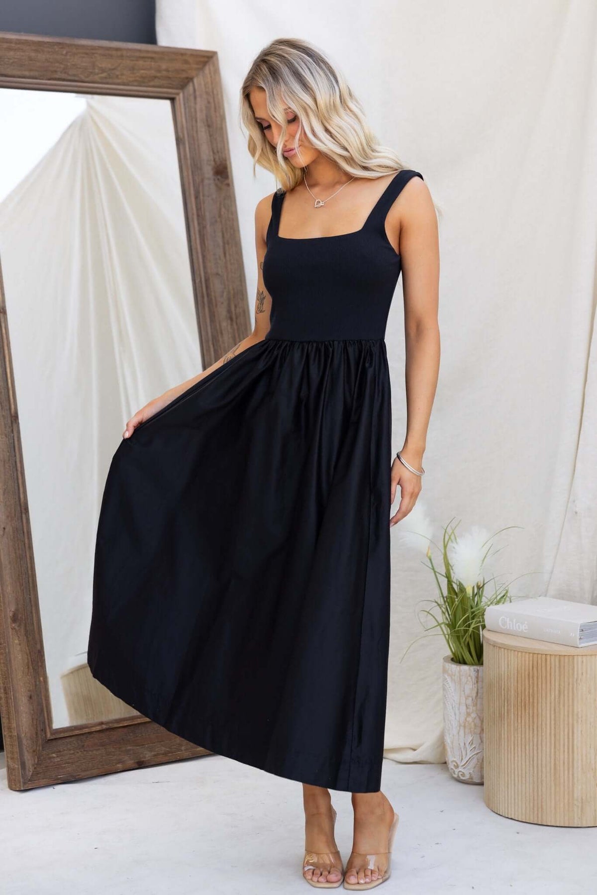 Flint Maxi Dress featuring a black jersey bodice with skirt pockets, modeled by a woman in a stylish, relaxed fit.