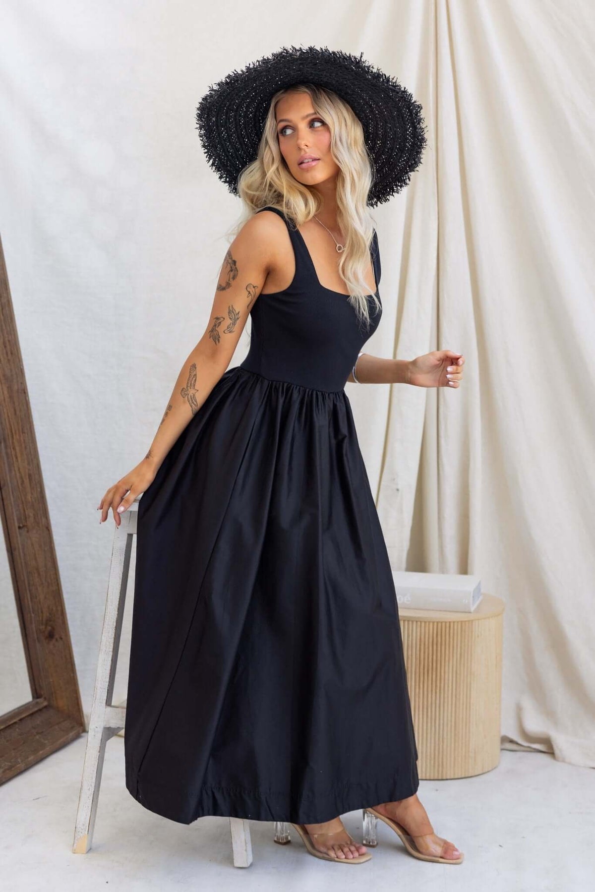 Flint Maxi Dress featuring a jersey bodice and pockets, styled with a wide-brimmed hat for a chic summer look.