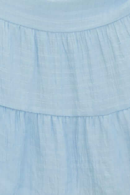Close-up of light blue fabric with a textured finish, showcasing the soft, airy quality of the Bindi Midi Dress.