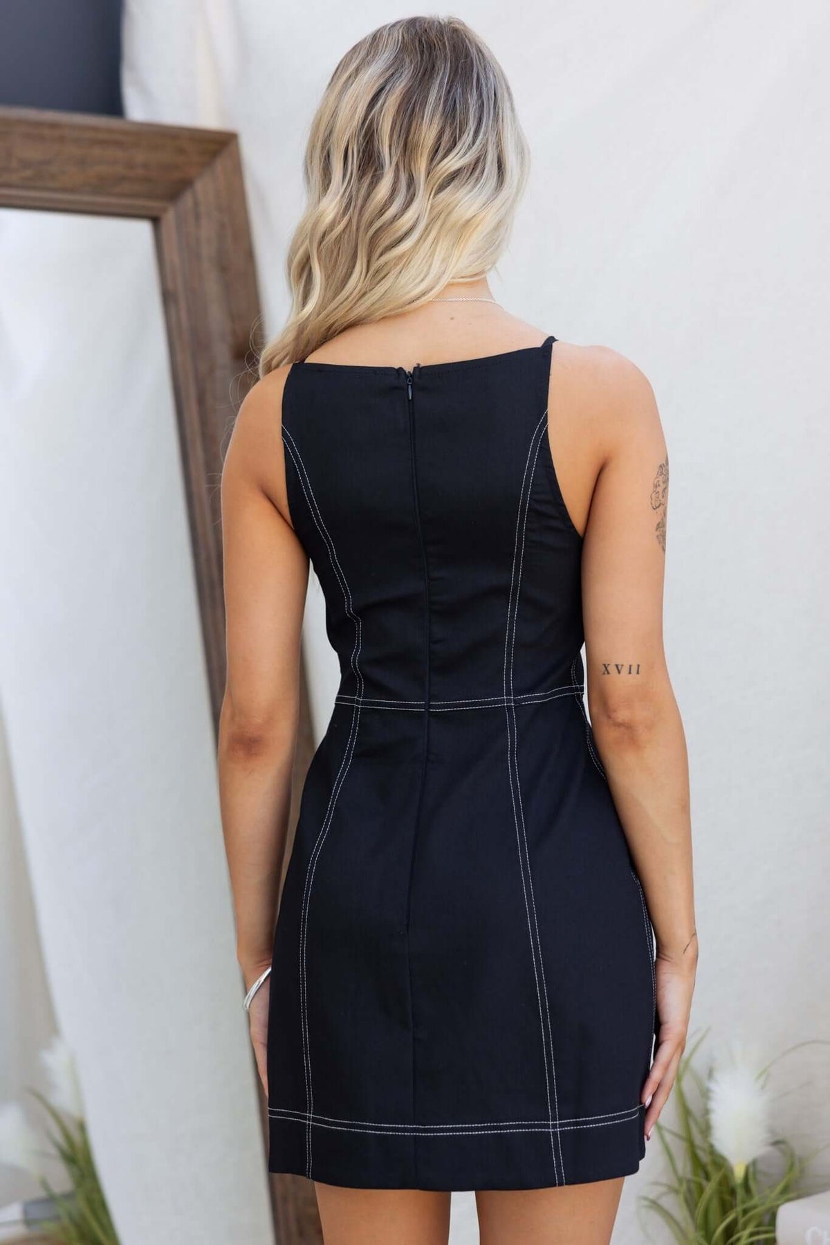 Back view of Olean Dress featuring faux buttons, invisible side zip, and lined cotton blend fabric.