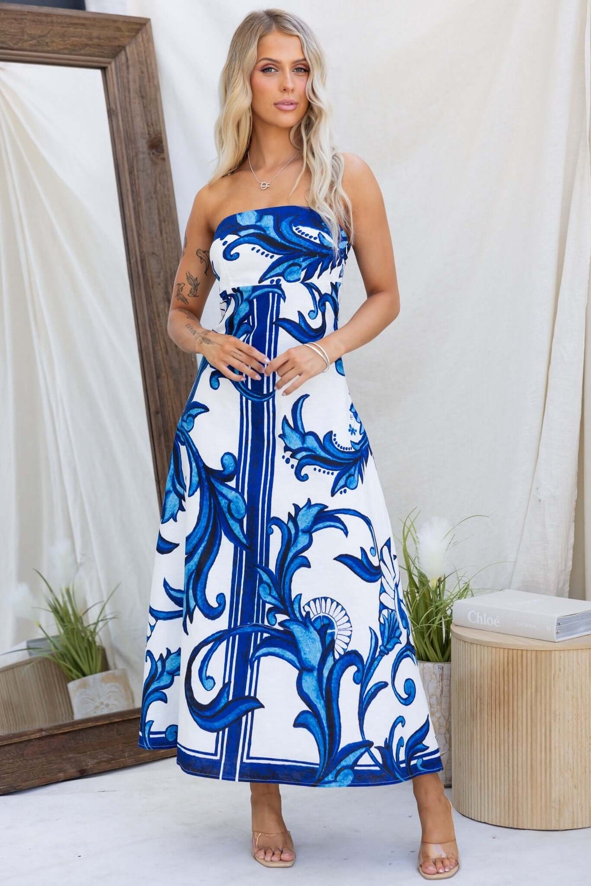 Strapless Montclair Maxi Dress featuring floral patterns in blue on a white background, showcasing a relaxed summer style.