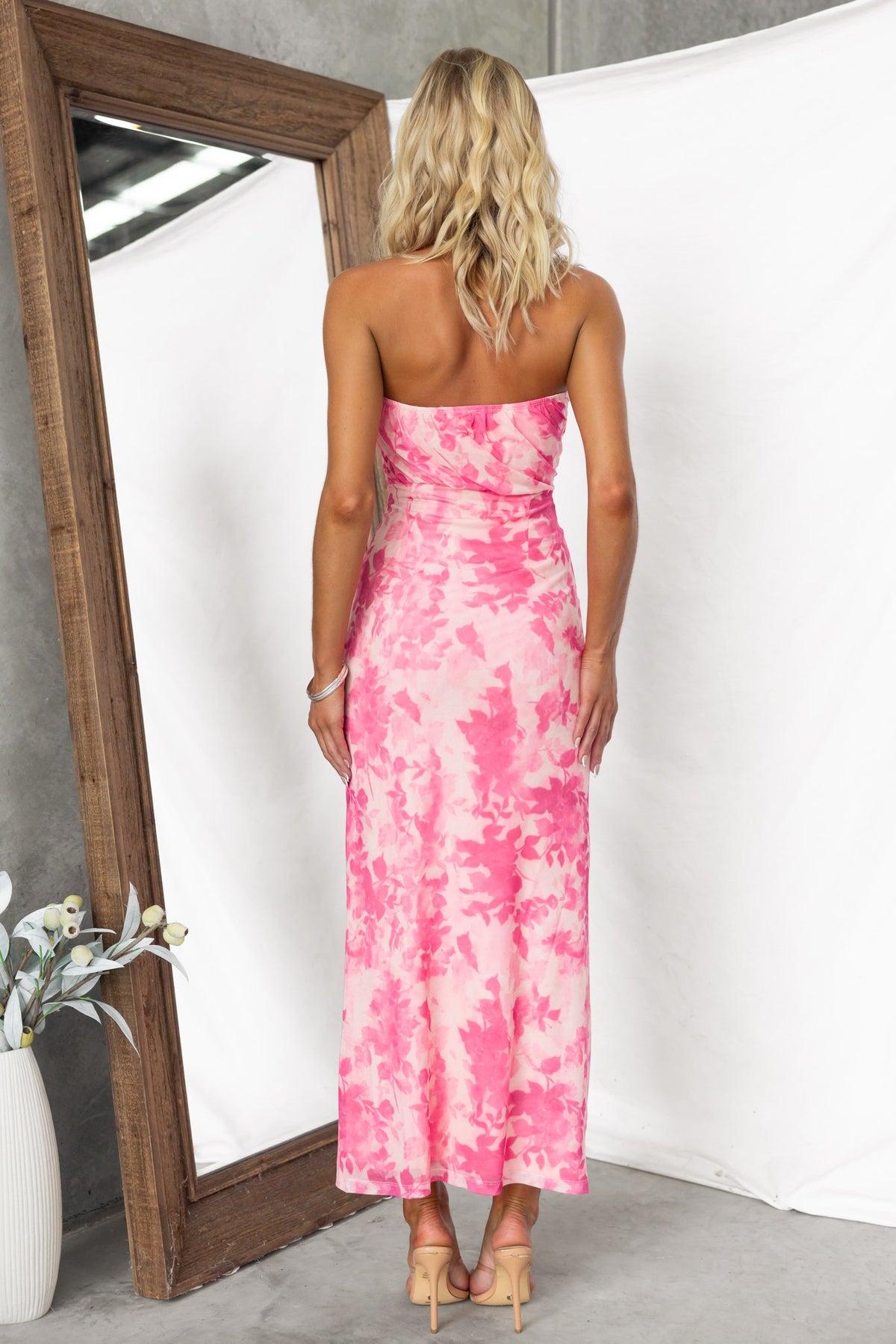 Katia maxi dress in pink floral print, strapless design, showcasing back view with mesh overlay and fitted silhouette.