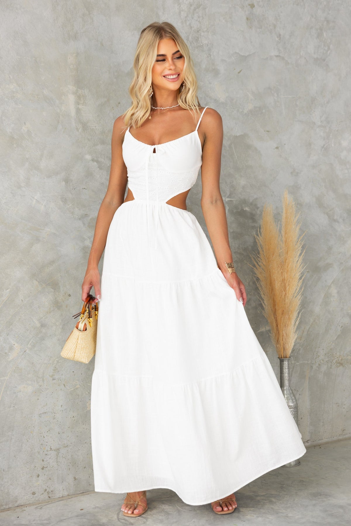 Noya Maxi Dress featuring adjustable straps and cut-out detail, styled with soft white cotton fabric.