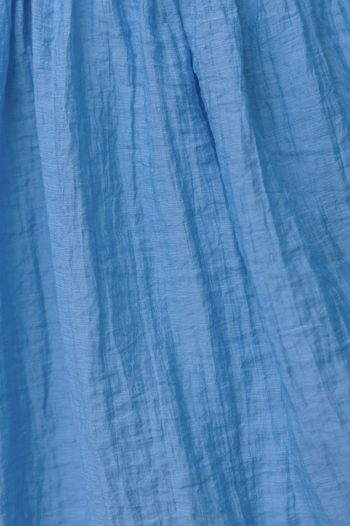 Close-up of light blue chiffon fabric texture of the Etsa Maxi Dress, showcasing its delicate, sheer quality.
