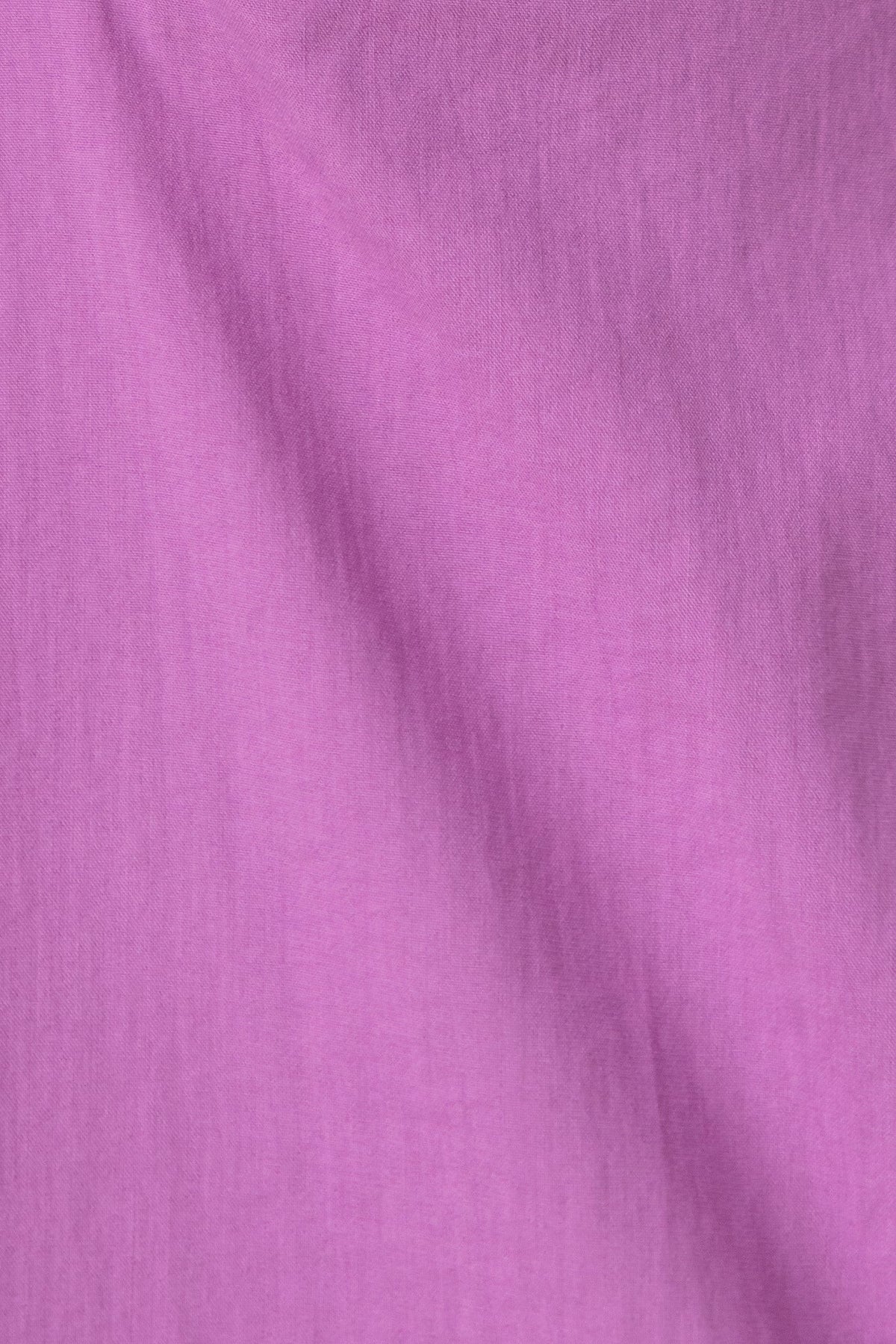 Close-up of light purple fabric texture, showcasing a soft and smooth finish for versatile dress designs.