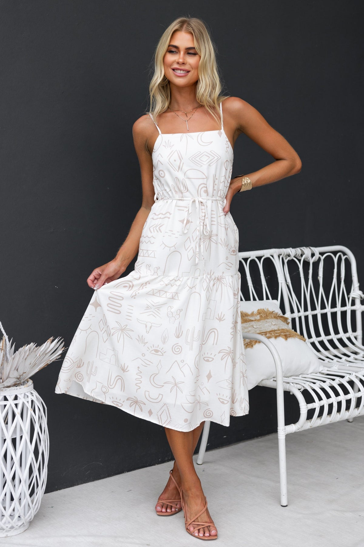 Orwell Midi Dress featuring adjustable straps and a removable tie, styled with comfortable sandals.