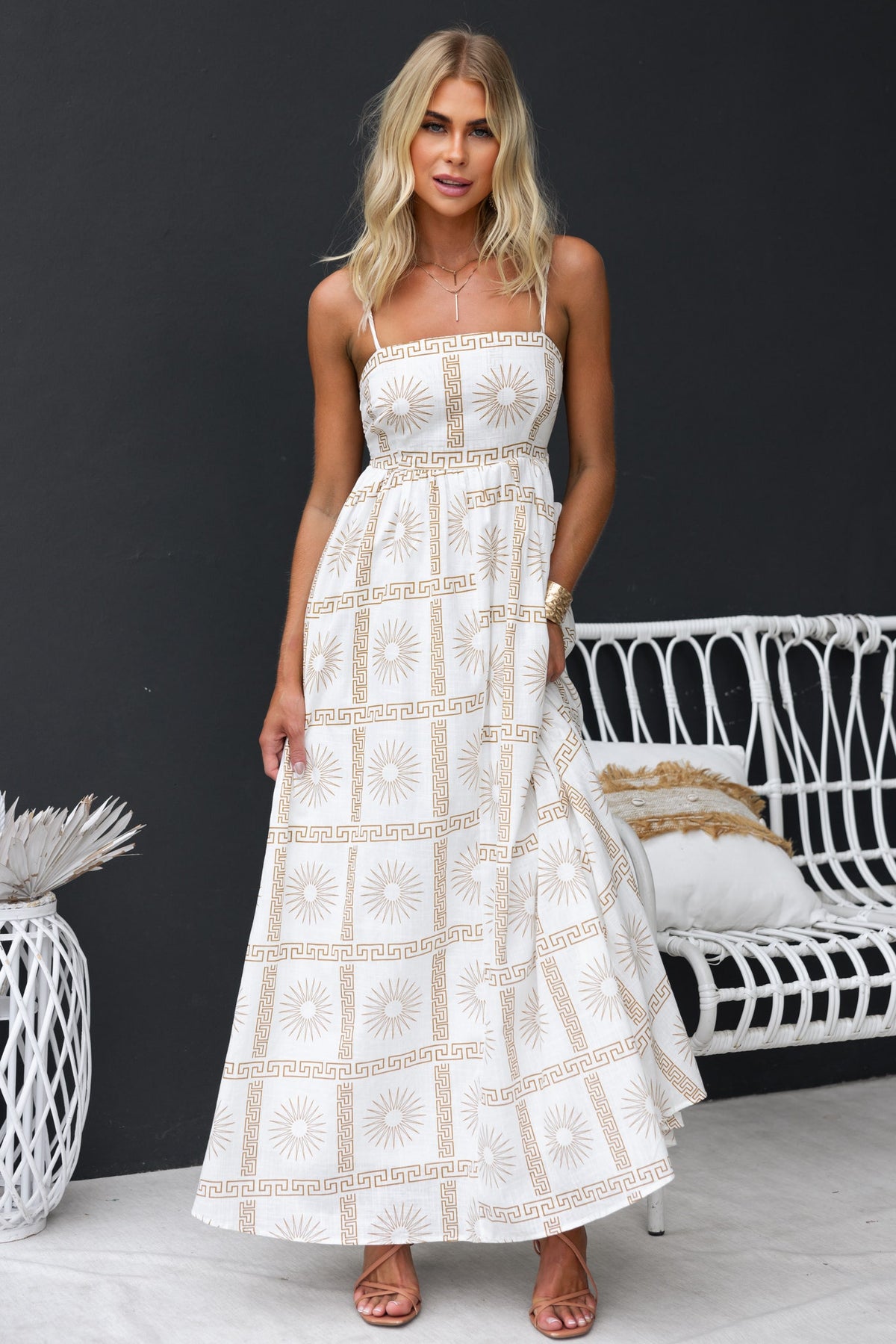 Stylish Bordeline Maxi Dress with abstract print, adjustable straps, and cut-out back, modeled by a woman in a chic setting.