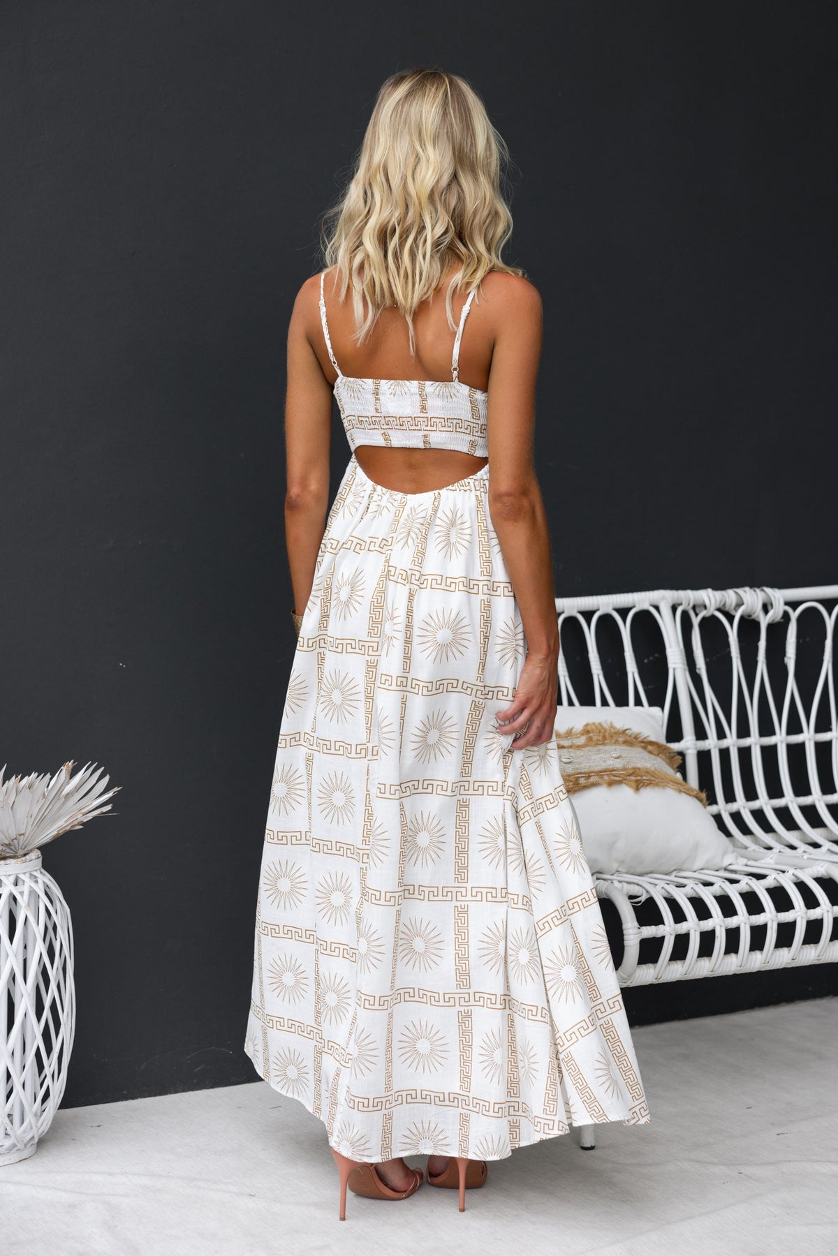 Back view of Bordeline Maxi Dress featuring abstract print, adjustable straps, and elegant cut-out detail.